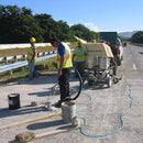 Construction workers filling cracks using the AST CMP 632 Dispensing System
