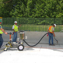 Workers using the AST CMP 632 dispensing system on new road