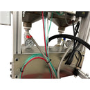 Backside of the AST GMP 025 system displaying two stainless steel tanks, pressure gauges, and color-coded tubing for fluid regulation.