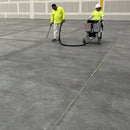 Two workers filling in cracks using the AST GMP-025 unit