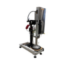 Angled front view of the AST SE-5 dispensing system, highlighting the pail ram, control panel, and air lines for automated operation.