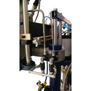 Side view of metering and control hardware on the HG 437 dispensing system, highlighting pneumatic components and cylinder mounts.