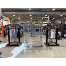 AST two-part adhesive cartridge filling system with dual 55-gallon drum pumps, pneumatic controls, and integrated filling station in industrial setting