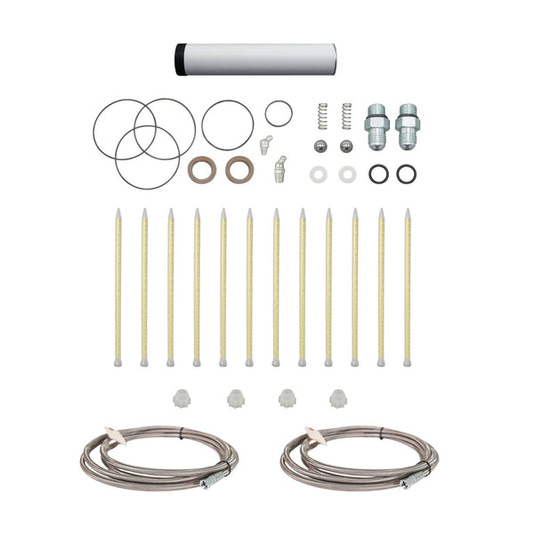 AST GMP-025 Spare Parts Kit showing replacement O-rings, fittings, springs, static mixers, and stainless steel braided hoses neatly arranged on a white background.