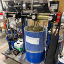 High-volume silicone dispensing system with dual pump setup dispensing two-part sealant from 55-gallon drum and 5-gallon pail