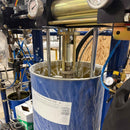 Close-up of follower plate and pump assembly inside 55-gallon drum for two-part silicone sealant dispensing system